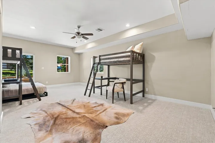 Recessed lighting, ceiling fan, natural light from multiple windows, and carpeted flooring