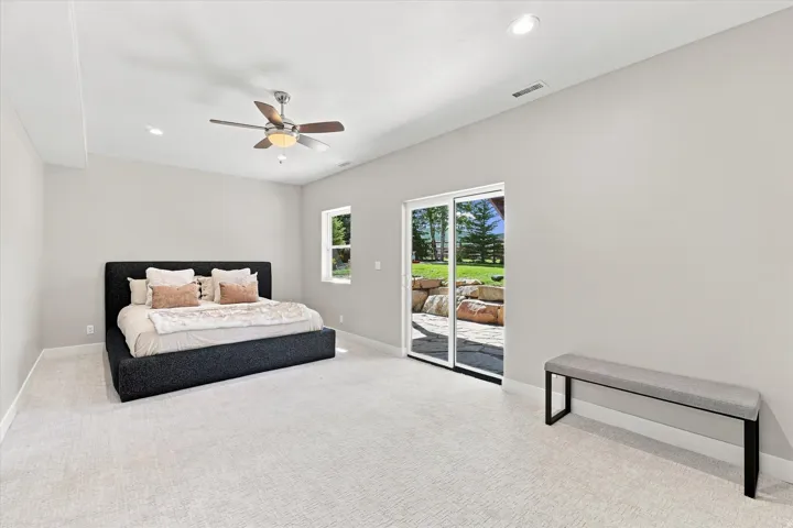 Recessed lighting, ceiling fan, carpet flooring, sliding glass door, and a window for natural light