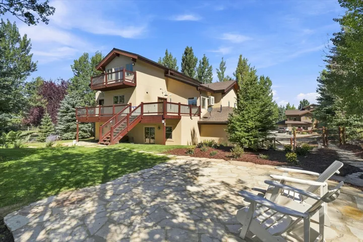 Multi-level exterior with a stucco finish and a shingle roof