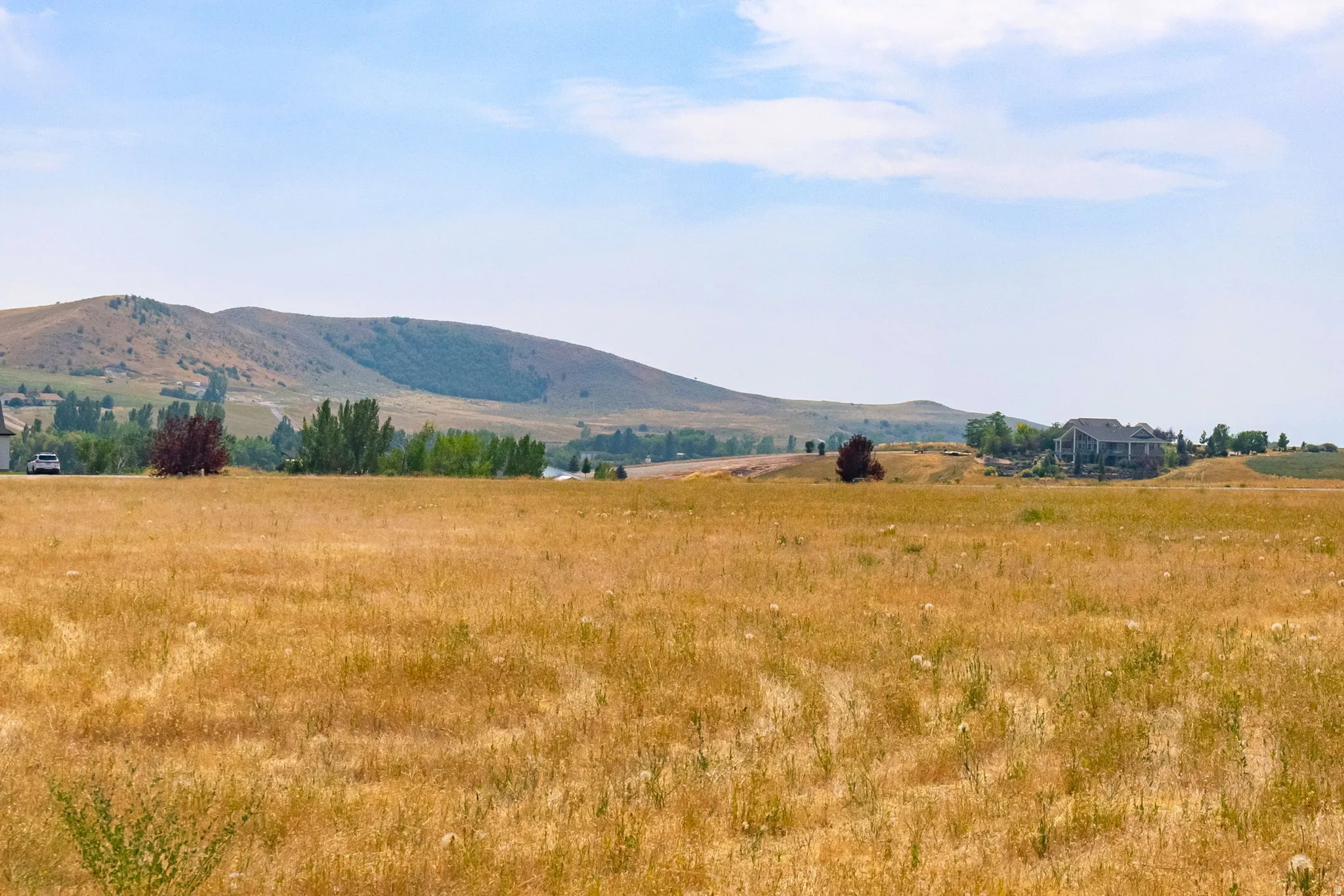 Expansive open land with distant hillside terrain
