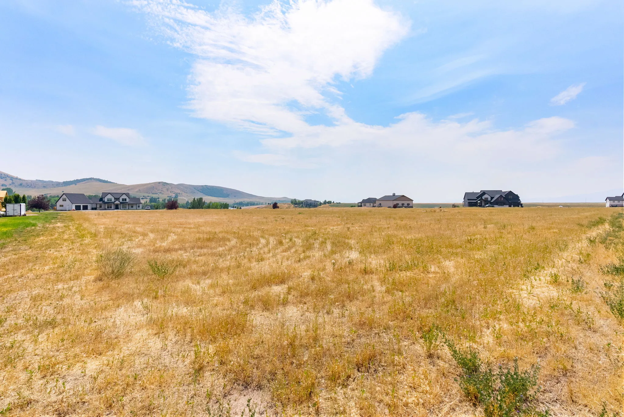 Expansive vacant land with a distant mountain backdrop