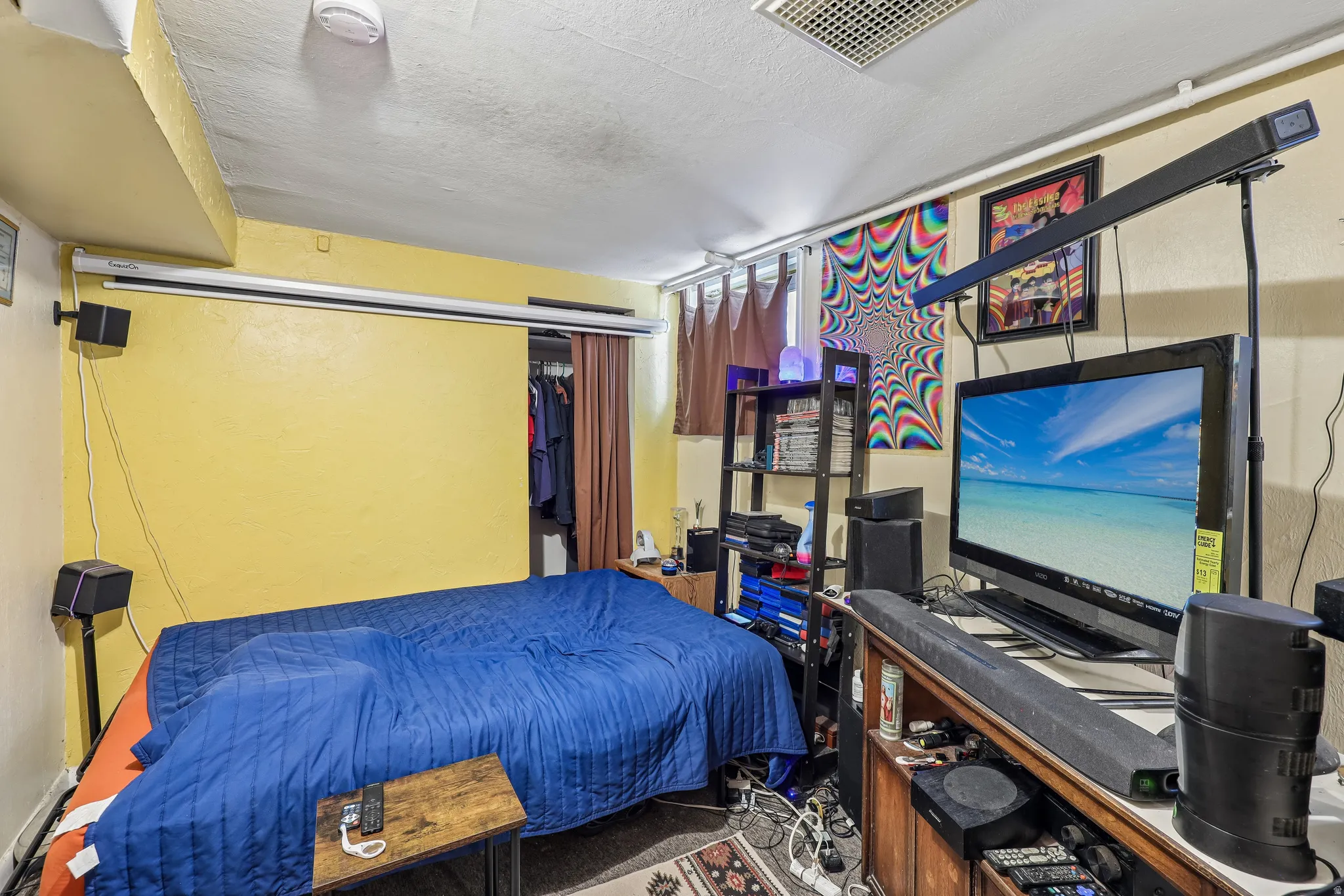 Wall-mounted projection screen above a recessed closet space