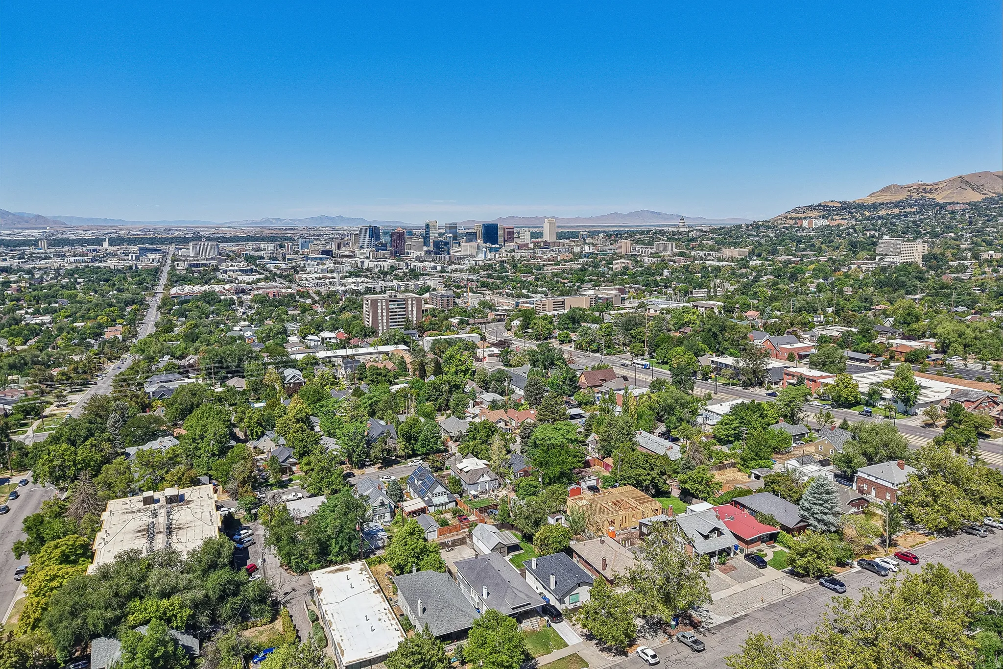Urban landscape featuring a distant city skyline and surrounding mountainous terrain
