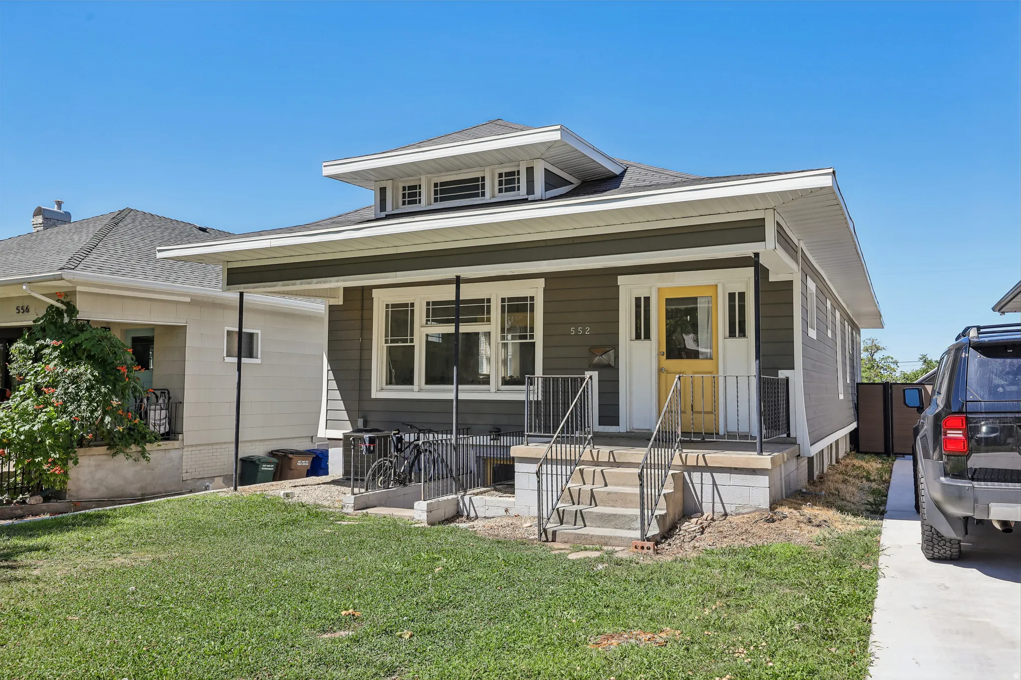 Craftsman-style home with gray siding and white trim
