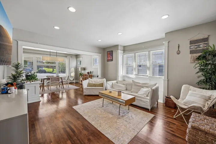 Hardwood flooring, recessed lighting, and expansive windows