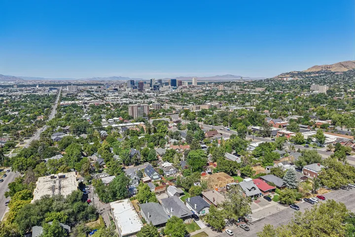 Urban landscape featuring a distant city skyline and surrounding mountainous terrain