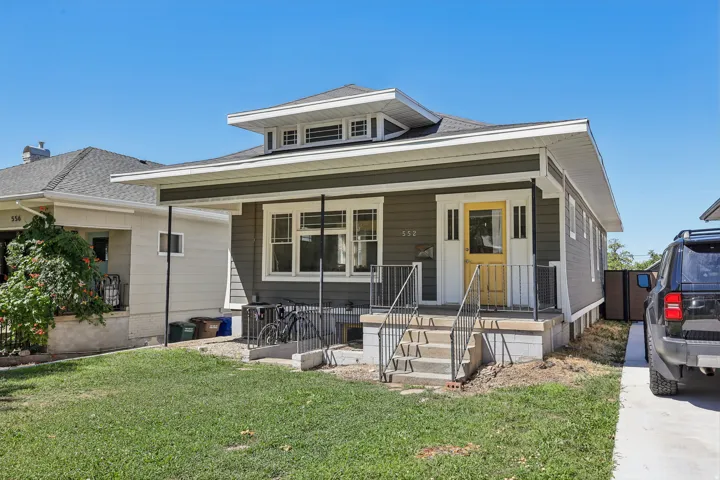 Craftsman-style home with gray siding and white trim