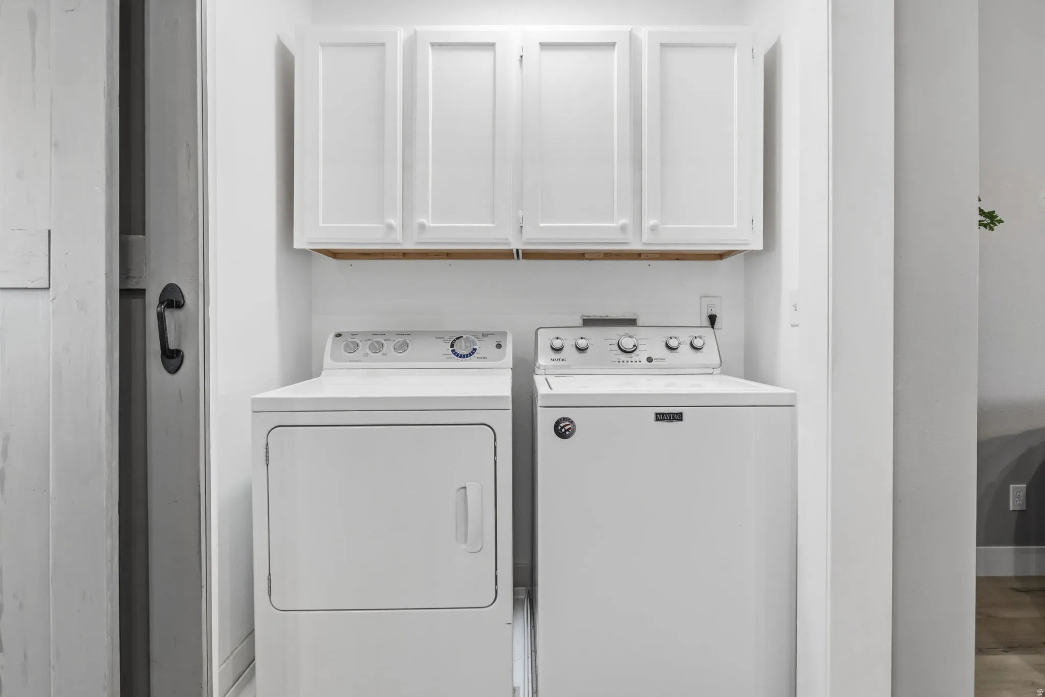 Convenient Main Floor Laundry cabinet behind barn door.