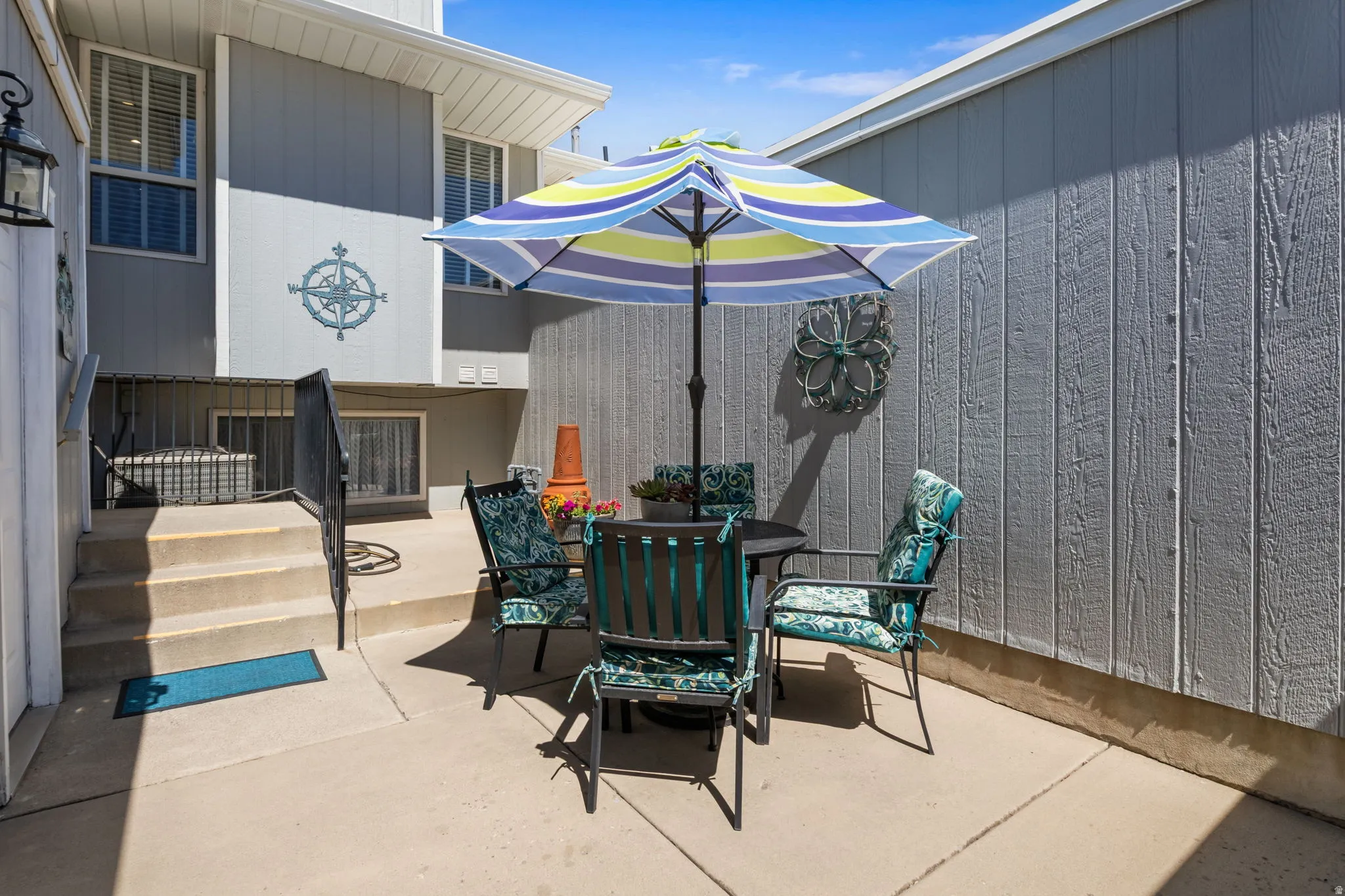 Concrete patio with stairs and metal railing