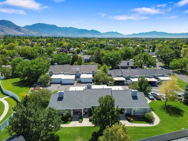 Expansive suburban setting with established trees and mountain scenery