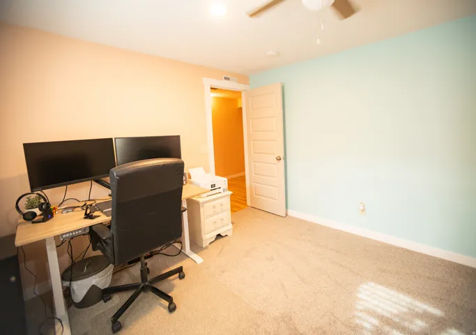 Recessed lighting, ceiling fan, carpeting, paneled door, and baseboard trim