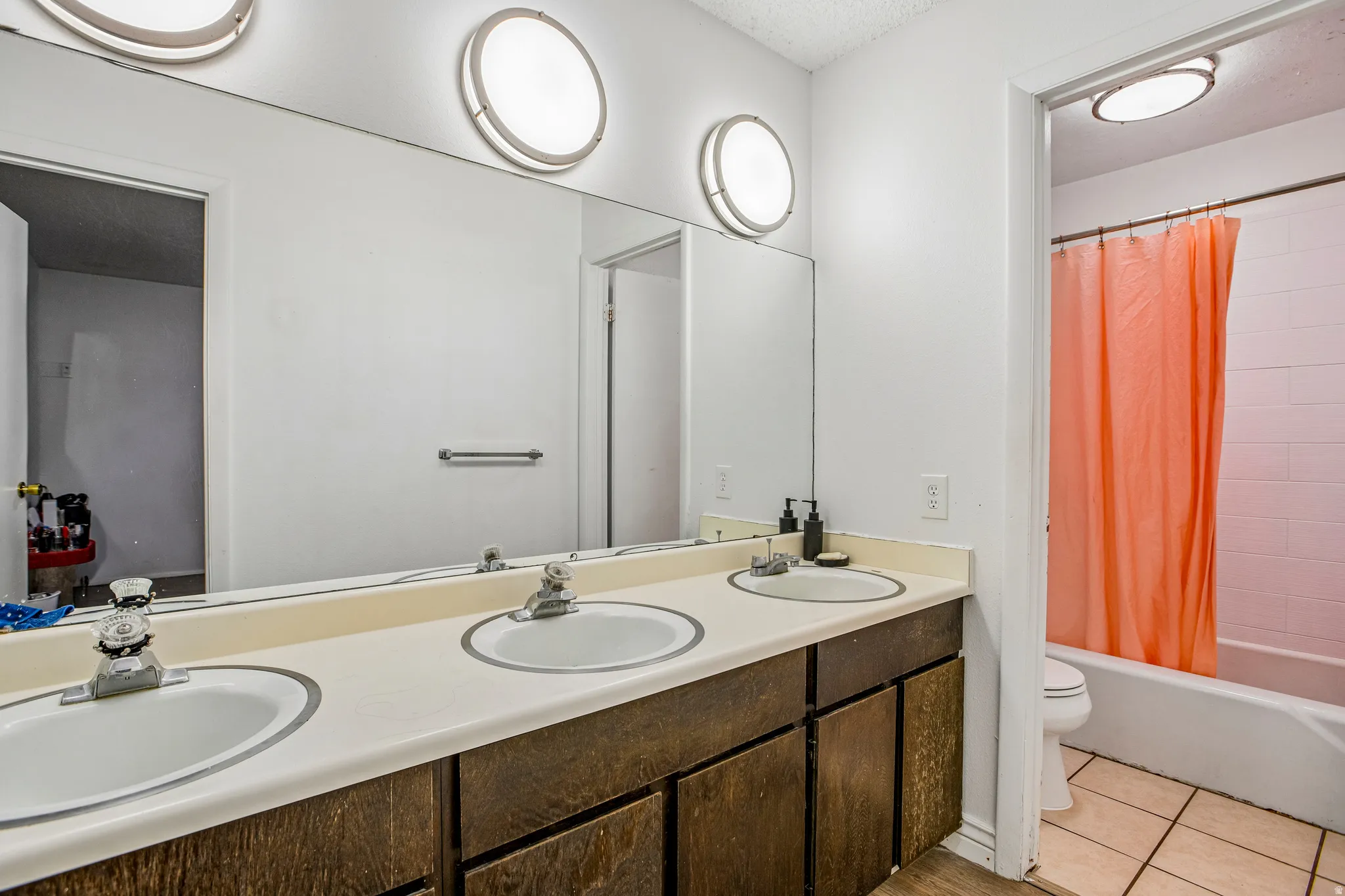 Dual vanity with integrated sinks and wood-finish cabinetry