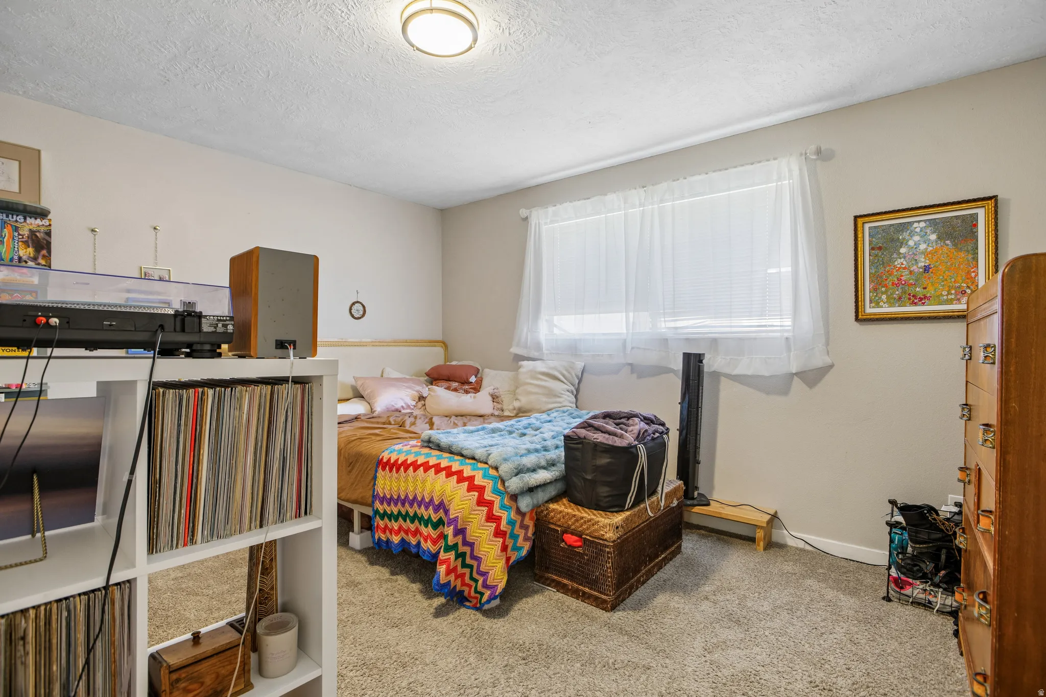 Neutral wall paint, ceiling-mounted light fixture, and carpeted flooring