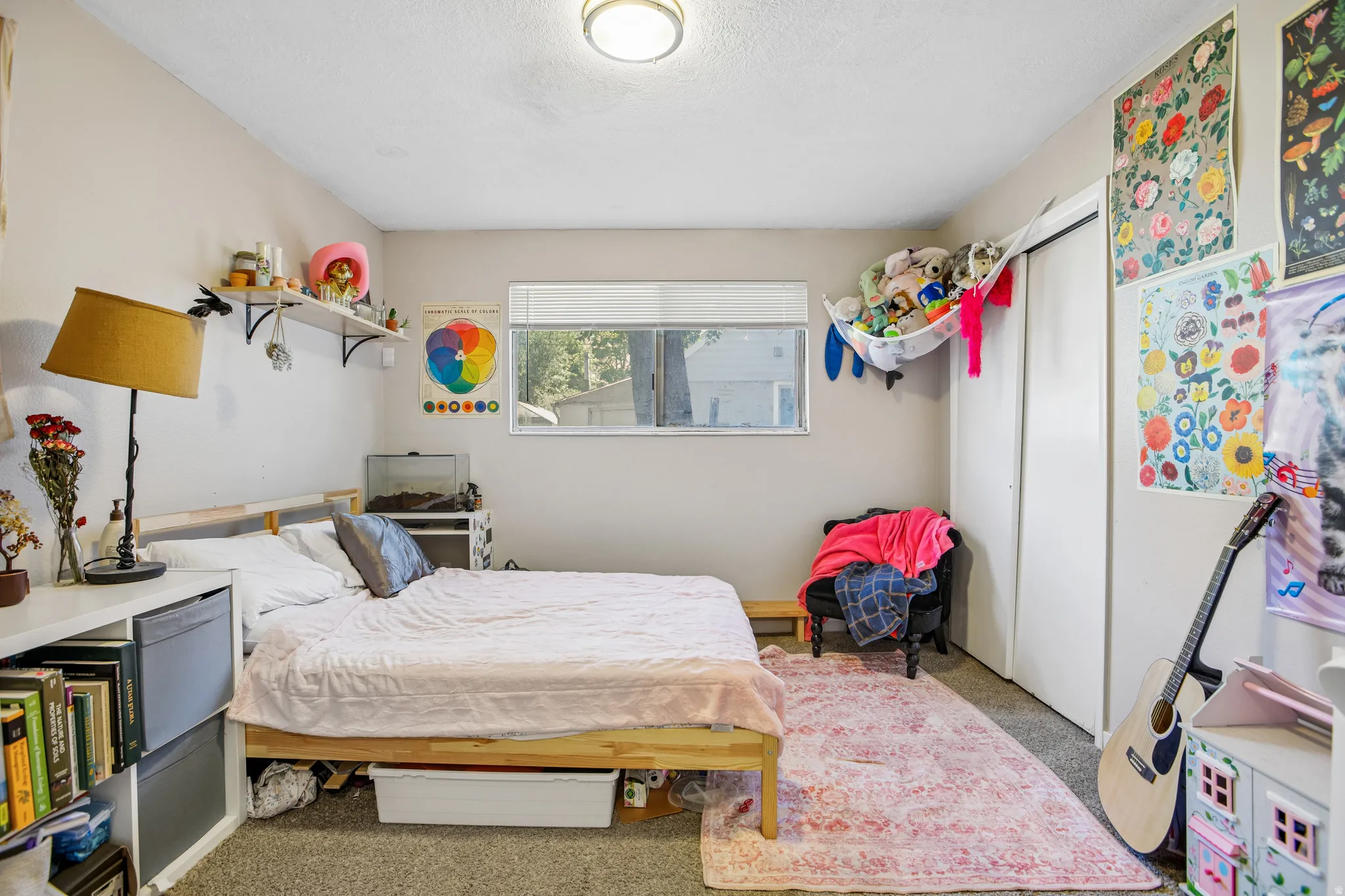 Wall-to-wall carpeting with light gray wall paint, featuring a horizontal window and a built-in closet with white doors