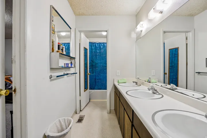 Double vanity with white oval sinks, chrome faucets, and integrated countertop