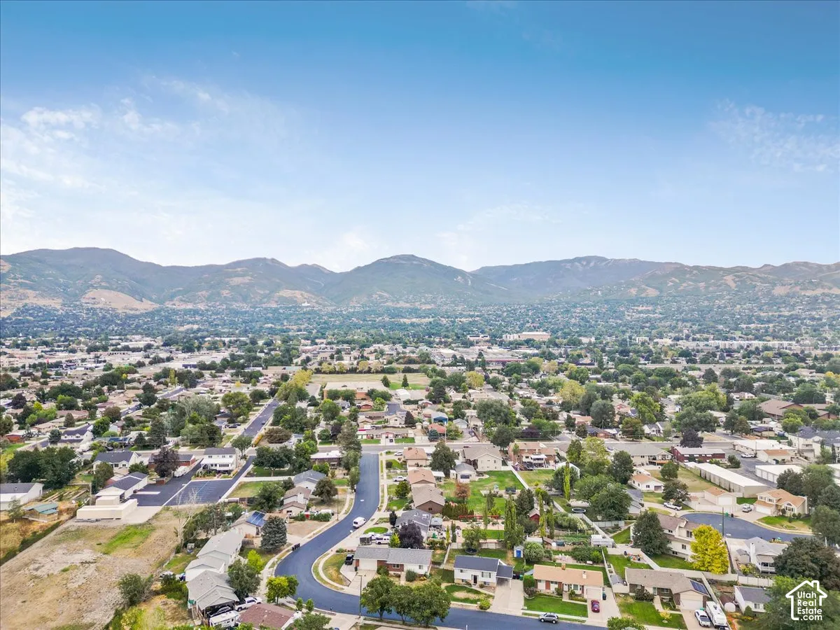 Expansive neighborhood setting with established homes, mature trees, and mountainous terrain
