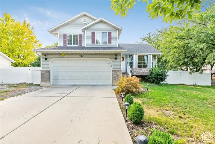 Two-story property featuring horizontal siding, a two-car garage, and a concrete driveway