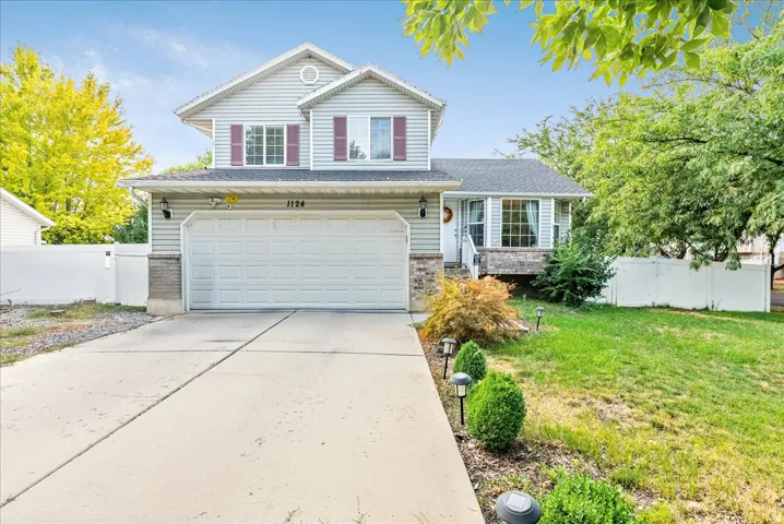 Two-story property featuring horizontal siding, a two-car garage, and a concrete driveway