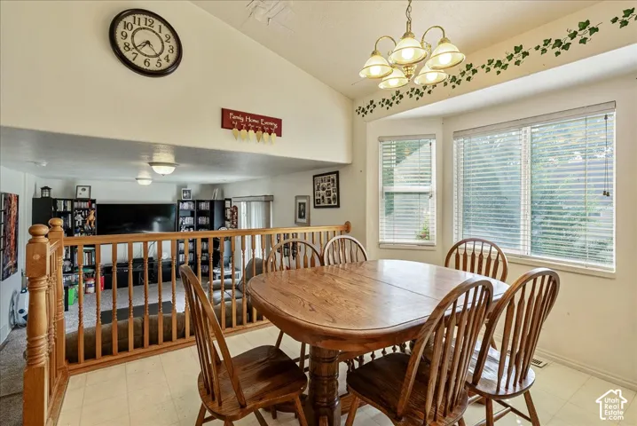 Recessed lighting, bay window, vaulted ceiling, wood railing, and ceiling-mounted light fixtures