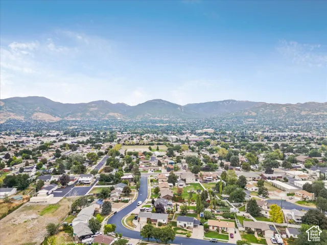 Expansive neighborhood setting with established homes, mature trees, and mountainous terrain