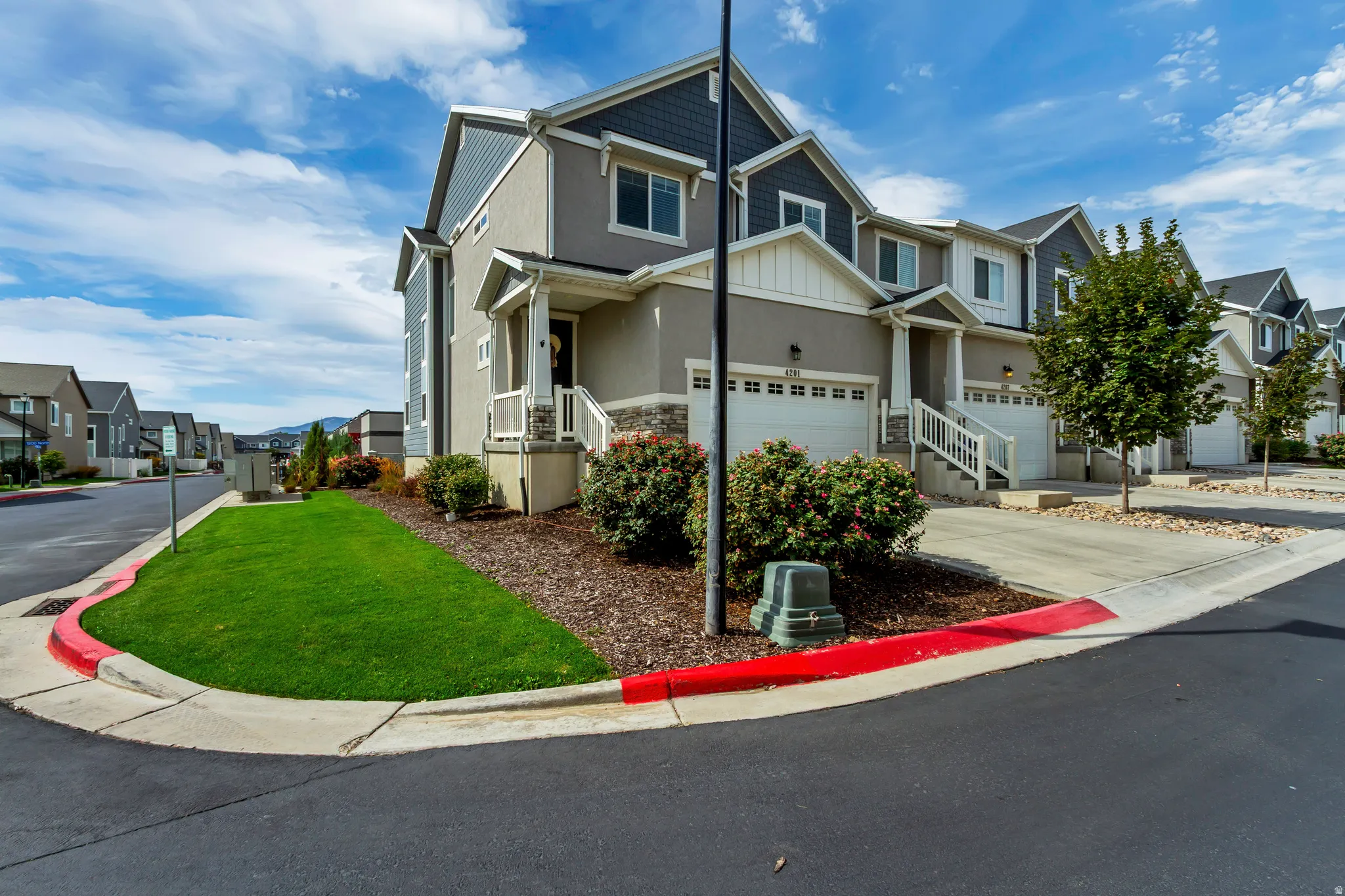 Contemporary multi-story exterior with stucco and siding elements.