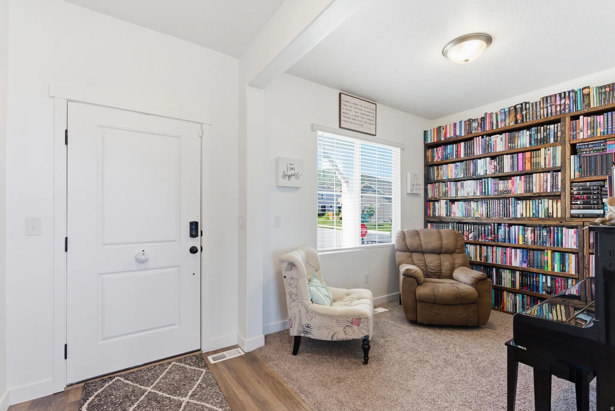 Hardwood-finish flooring, built-in shelving, window with blinds, and recessed lighting