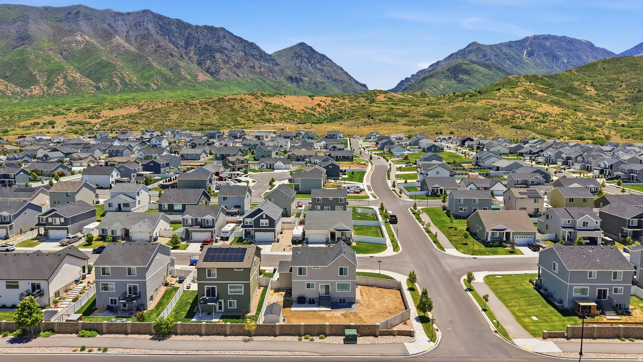 Residential development with paved roads and mountain backdrop