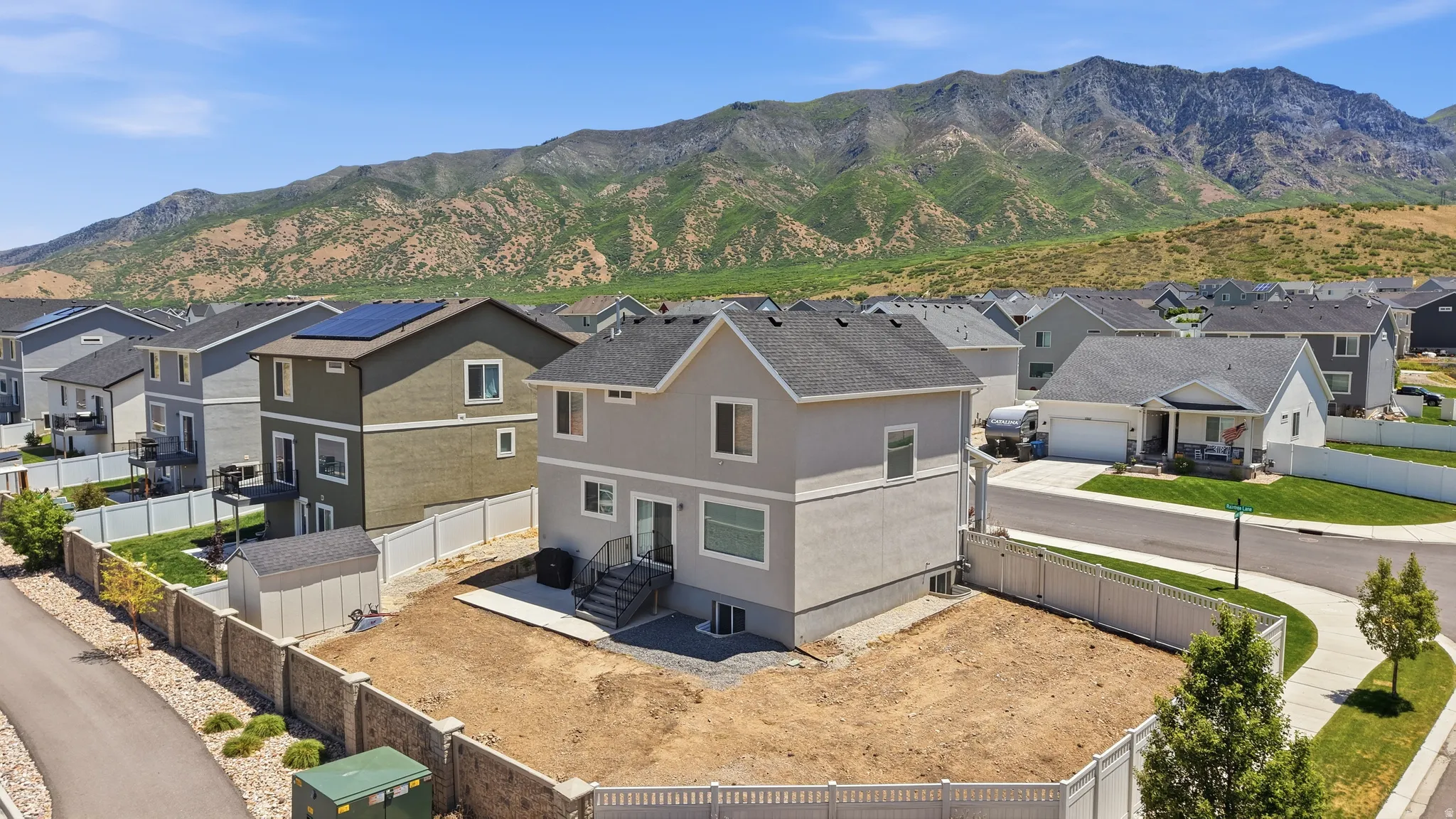 Spacious backyard area, mountain backdrop, and neighborhood setting