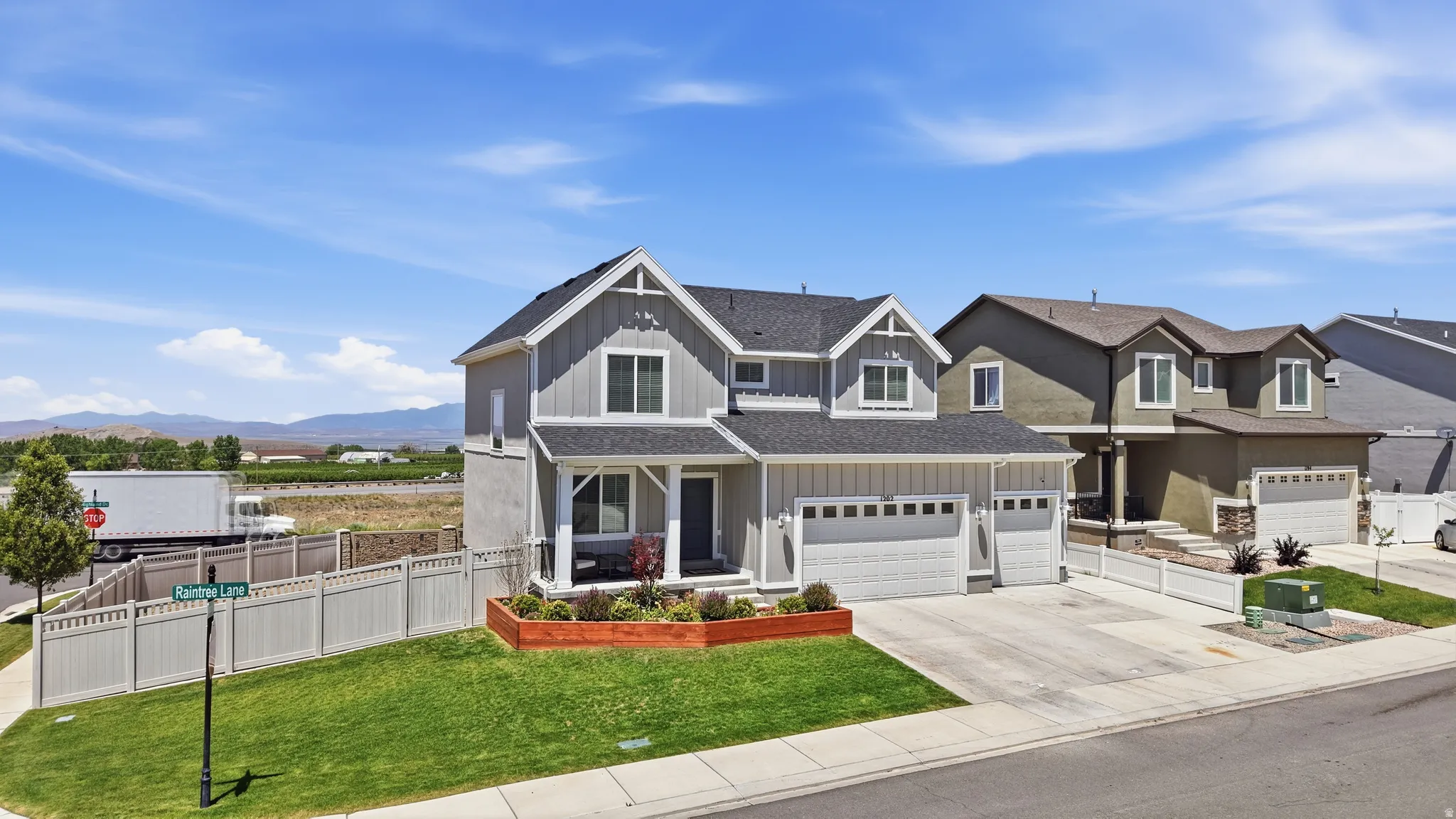 Contemporary two-story residence with a multi-gabled roofline, board-and-batten siding, and an attached two-car garage