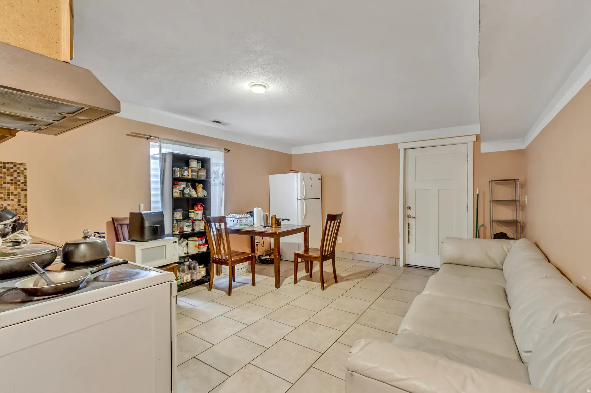 Tile flooring, recessed lighting, and a paneled door