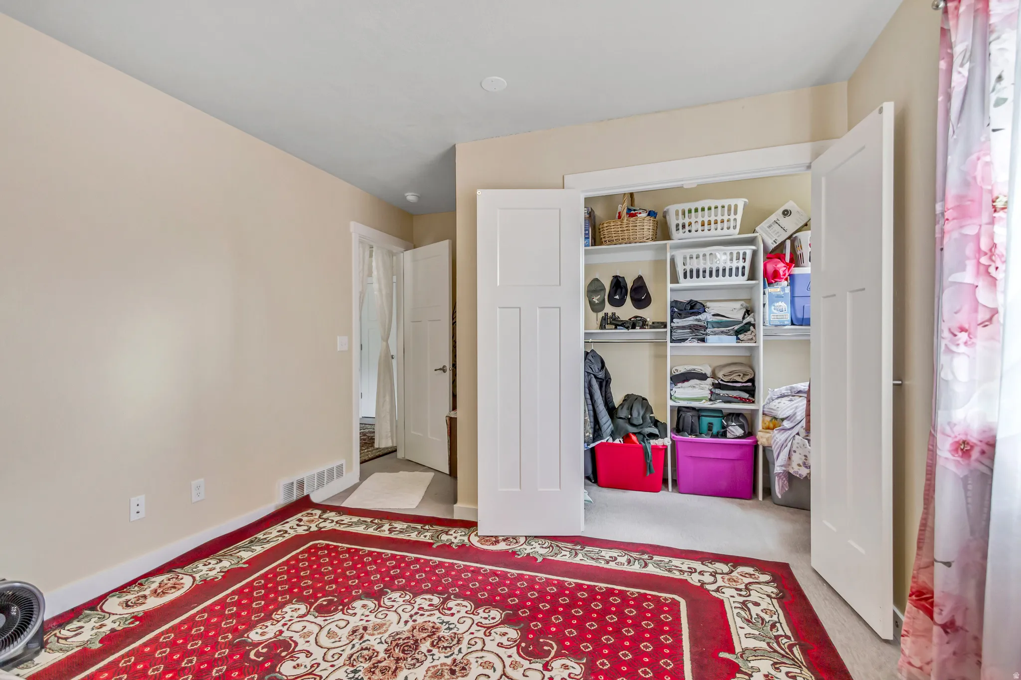 Recessed lighting, painted walls, white trim, and a built-in closet with shelving