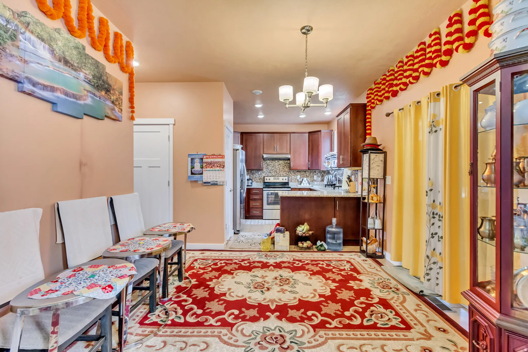 Kitchen featuring wood-finish cabinetry, stainless steel appliances, and a mosaic tile backsplash