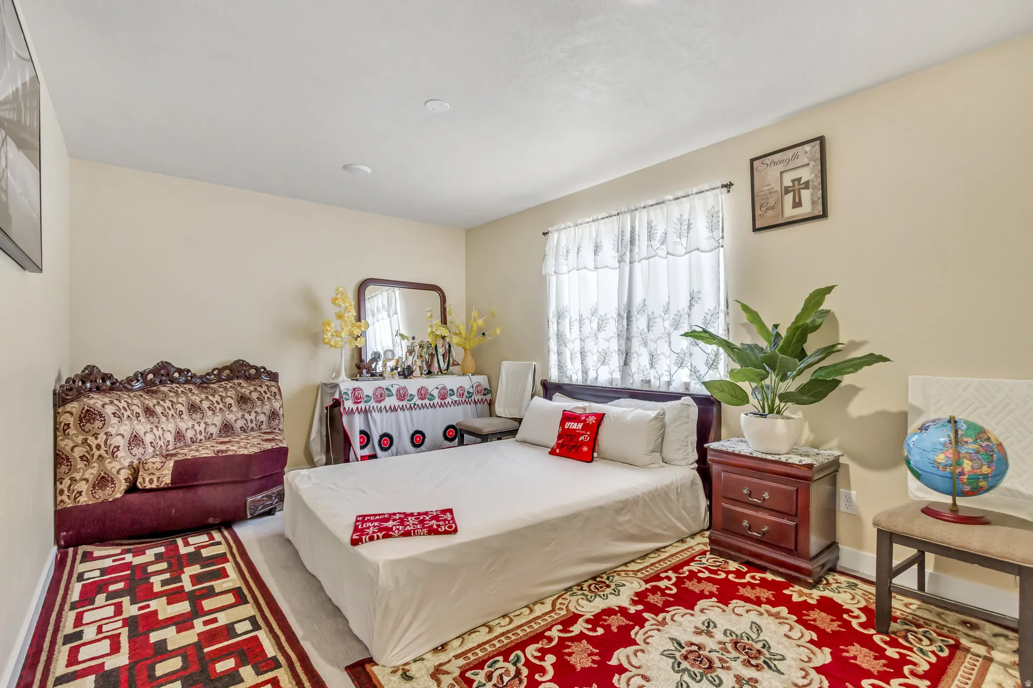 Recessed ceiling lighting, light-toned walls, and a window with sheer coverings