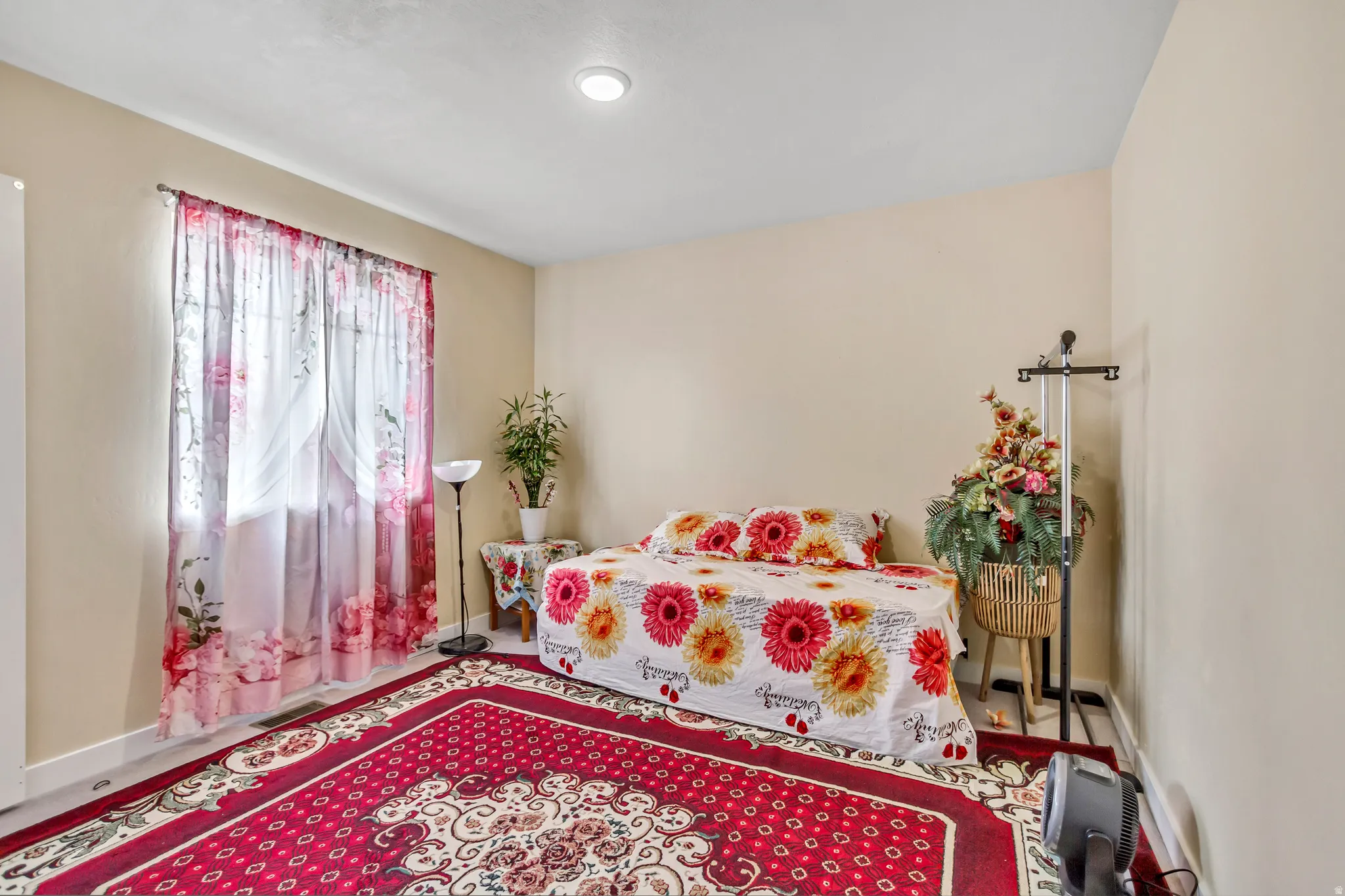 Recessed ceiling lighting, light-toned walls, and a window with sheer curtains