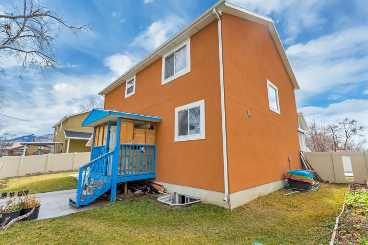 Orange exterior siding with white trim and a contrasting blue covered porch
