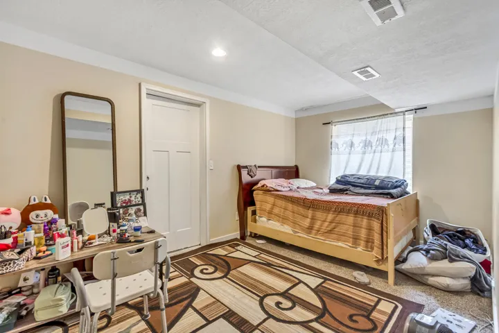 Recessed lighting, window with curtain rod, and a solid interior door