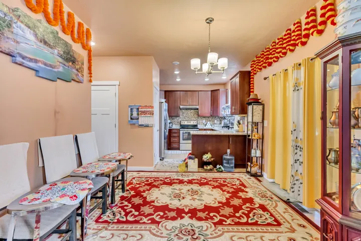 Kitchen featuring wood-finish cabinetry, stainless steel appliances, and a mosaic tile backsplash
