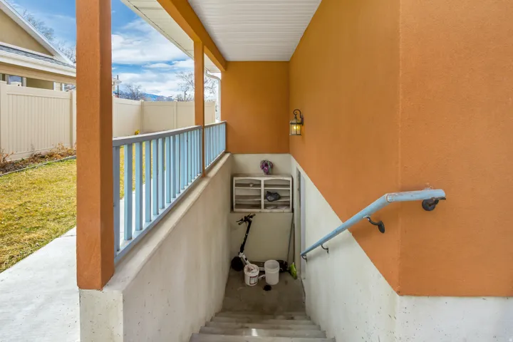 Concrete walkway leading to a recessed entryway with a light fixture