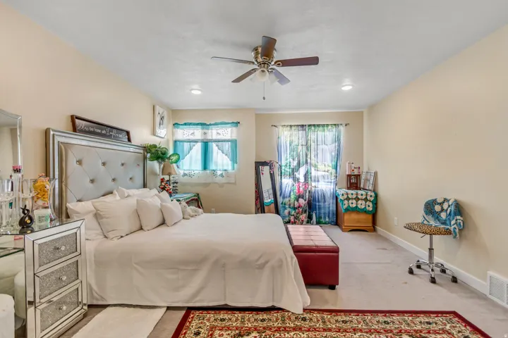 Recessed lighting, ceiling fan, and light-toned walls