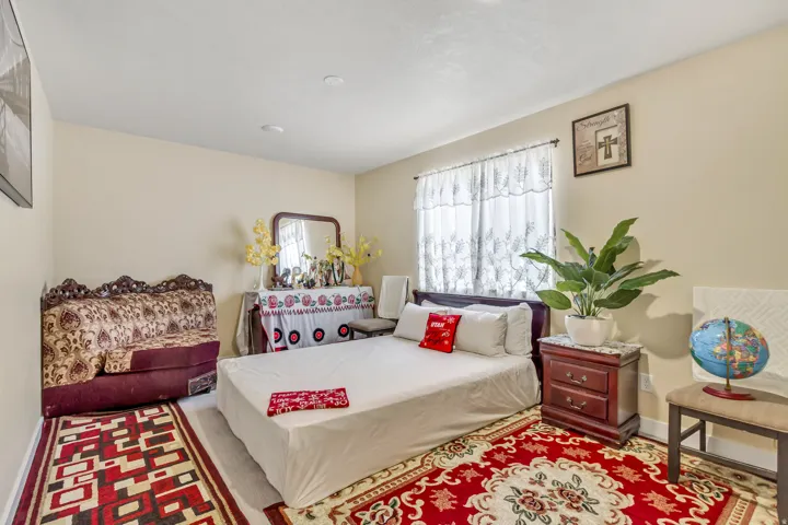 Recessed ceiling lighting, light-toned walls, and a window with sheer coverings