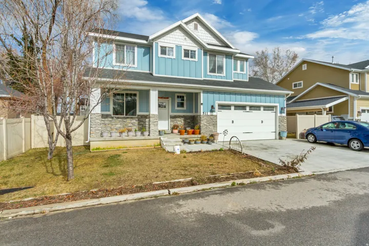 Two-story residence featuring blue vertical siding and white horizontal siding accents
