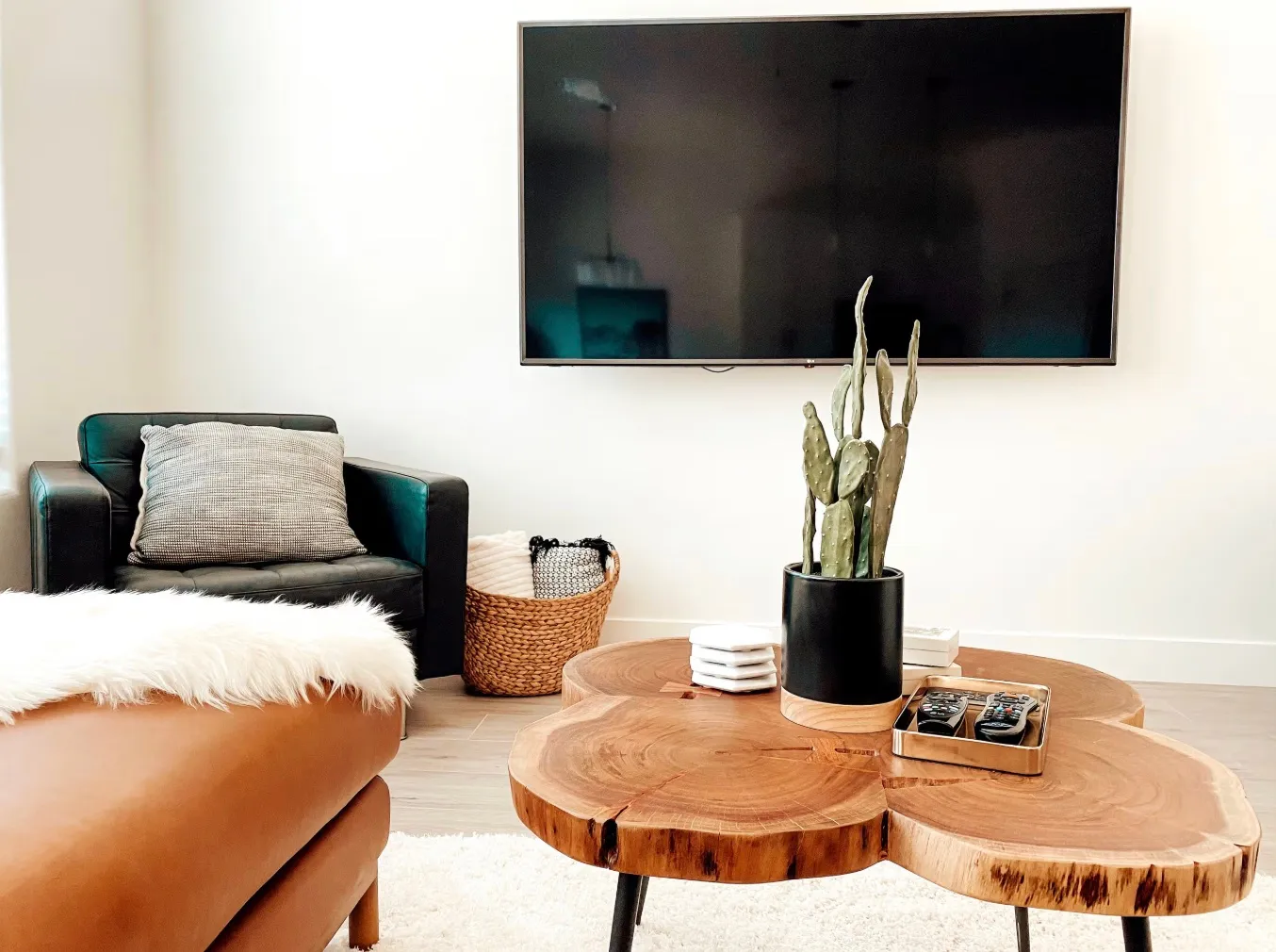 Wall-mounted television with wood-finish flooring