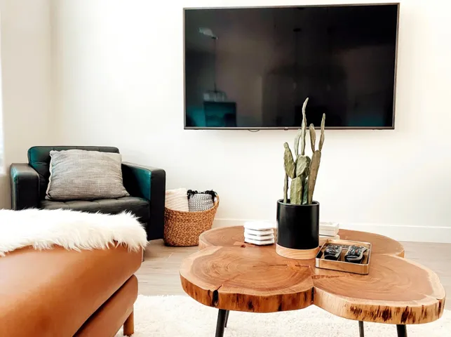 Wall-mounted television with wood-finish flooring