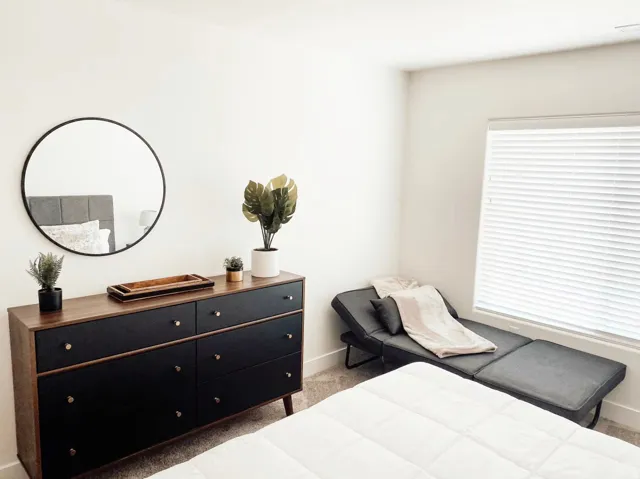 White walls with a window featuring horizontal blinds