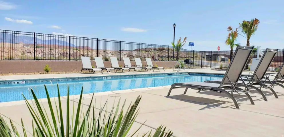 Outdoor swimming pool with integrated steps, surrounded by a concrete deck