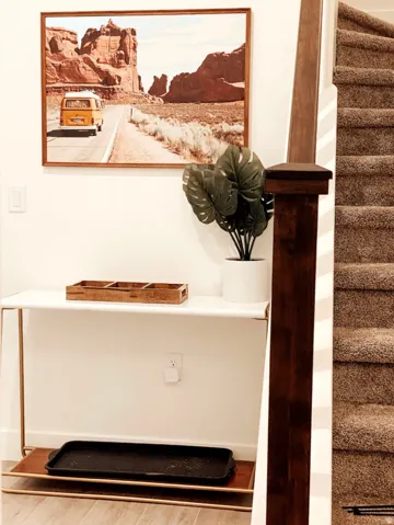 Staircase featuring carpeted treads and a dark wood newel post