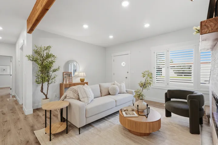 Recessed lighting, wood-finish flooring, white plantation shutters, exposed wood beam