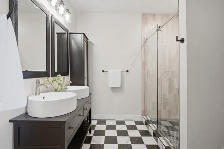 Modern bathroom en-suite with jack and jill sinks and large standing shower.