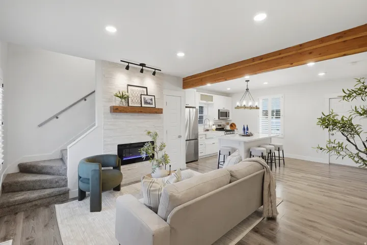 Open-concept living space, exposed beam. Fireplace with blower.