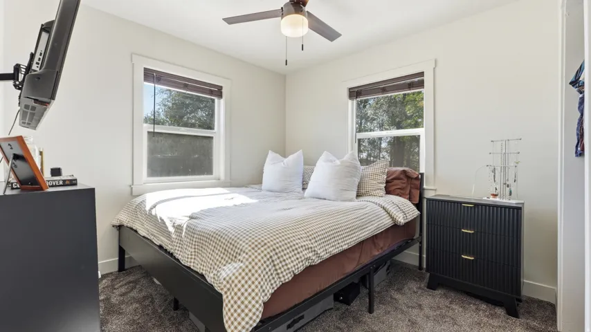 Recessed lighting, ceiling fan with light fixture, dual windows with white trim, and neutral wall tones